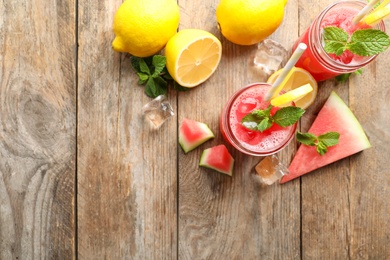 Photo of Delicious fresh watermelon drink on wooden table, flat lay. Space for text