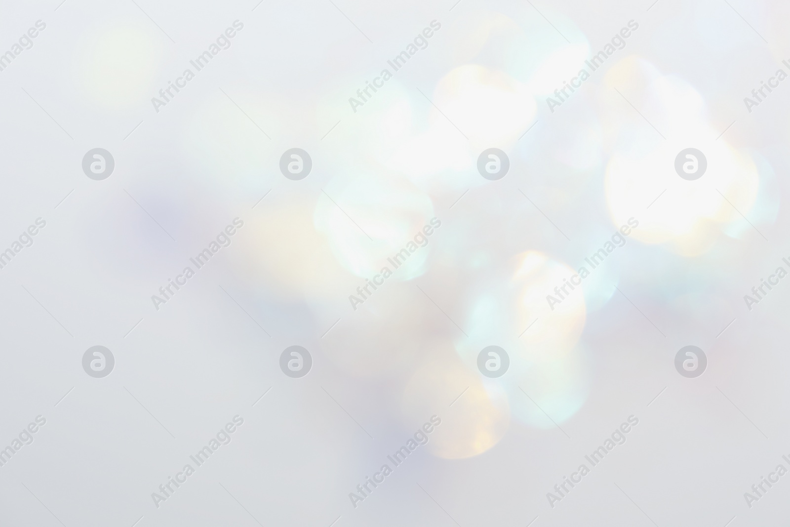 Image of Blurred view of shiny lights on white background. Bokeh effect