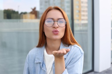 Portrait of beautiful woman in glasses outdoors