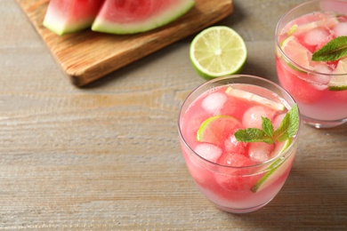 Tasty refreshing watermelon drink on wooden table. Space for text