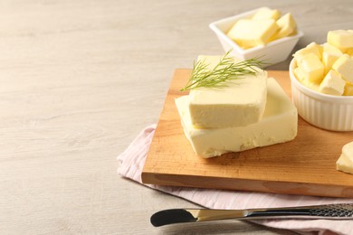 Tasty butter with dill and knife on wooden table. Space for text