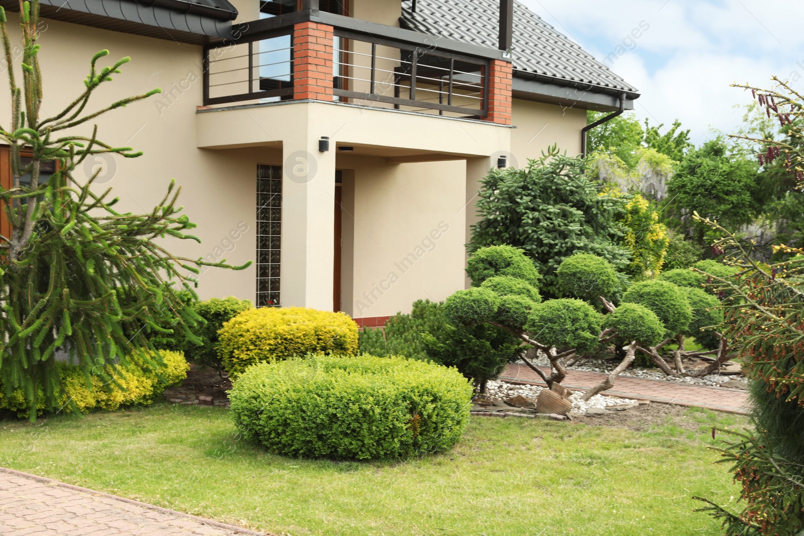 Photo of Picturesque view of beautiful house and garden on sunny day