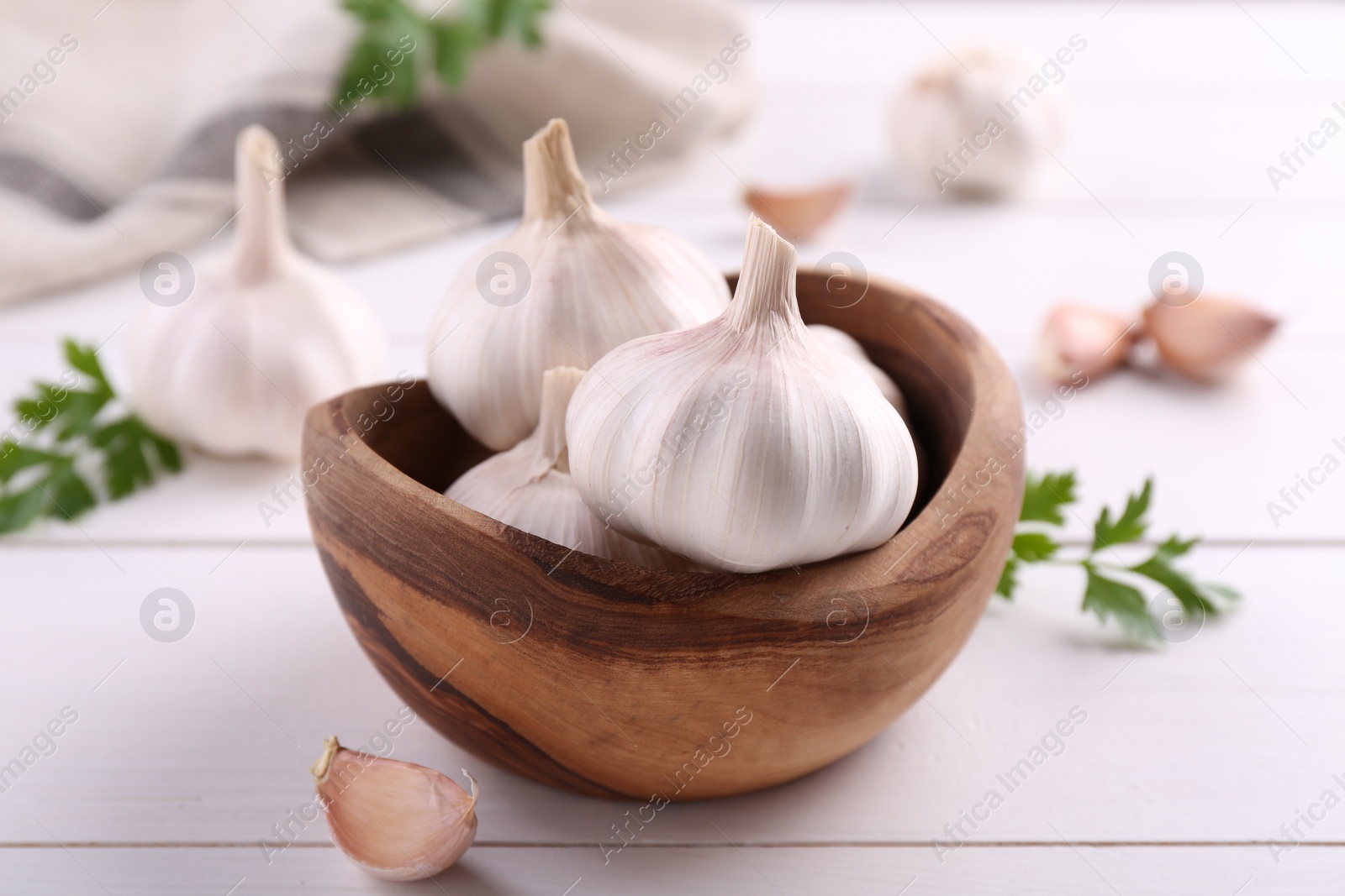 Photo of Fresh garlic on white wooden table, closeup