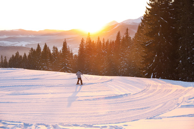 Photo of Skier on snowy slope at resort. Winter vacation
