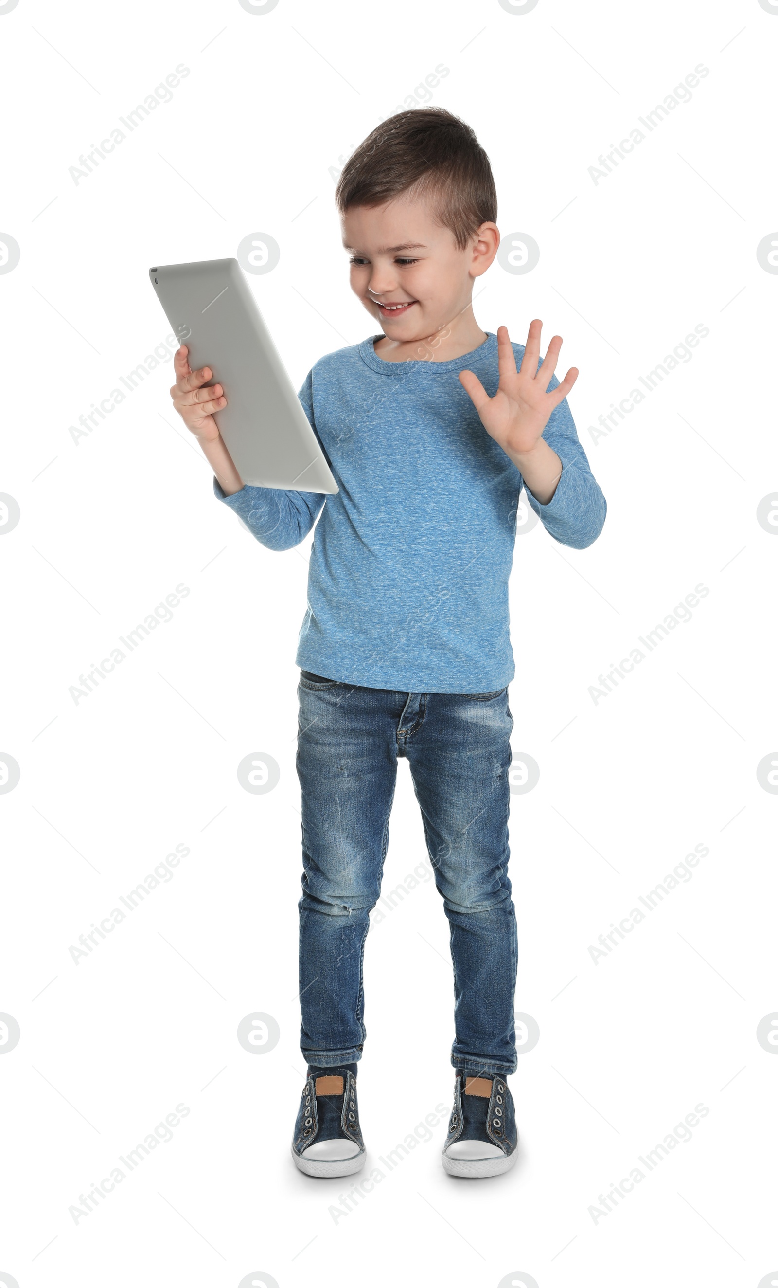 Photo of Little boy using video chat on tablet, white background