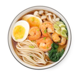 Delicious ramen with shrimps and egg in bowl isolated on white, top view. Noodle soup