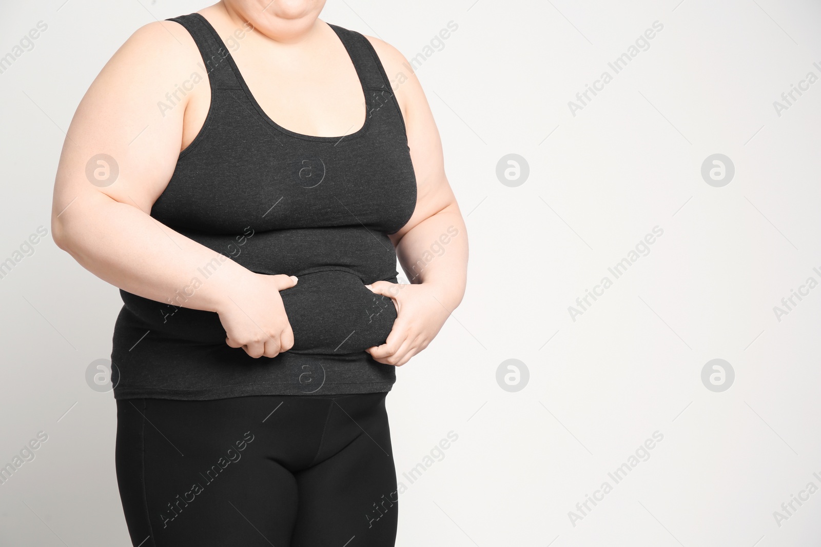 Photo of Overweight woman on light background