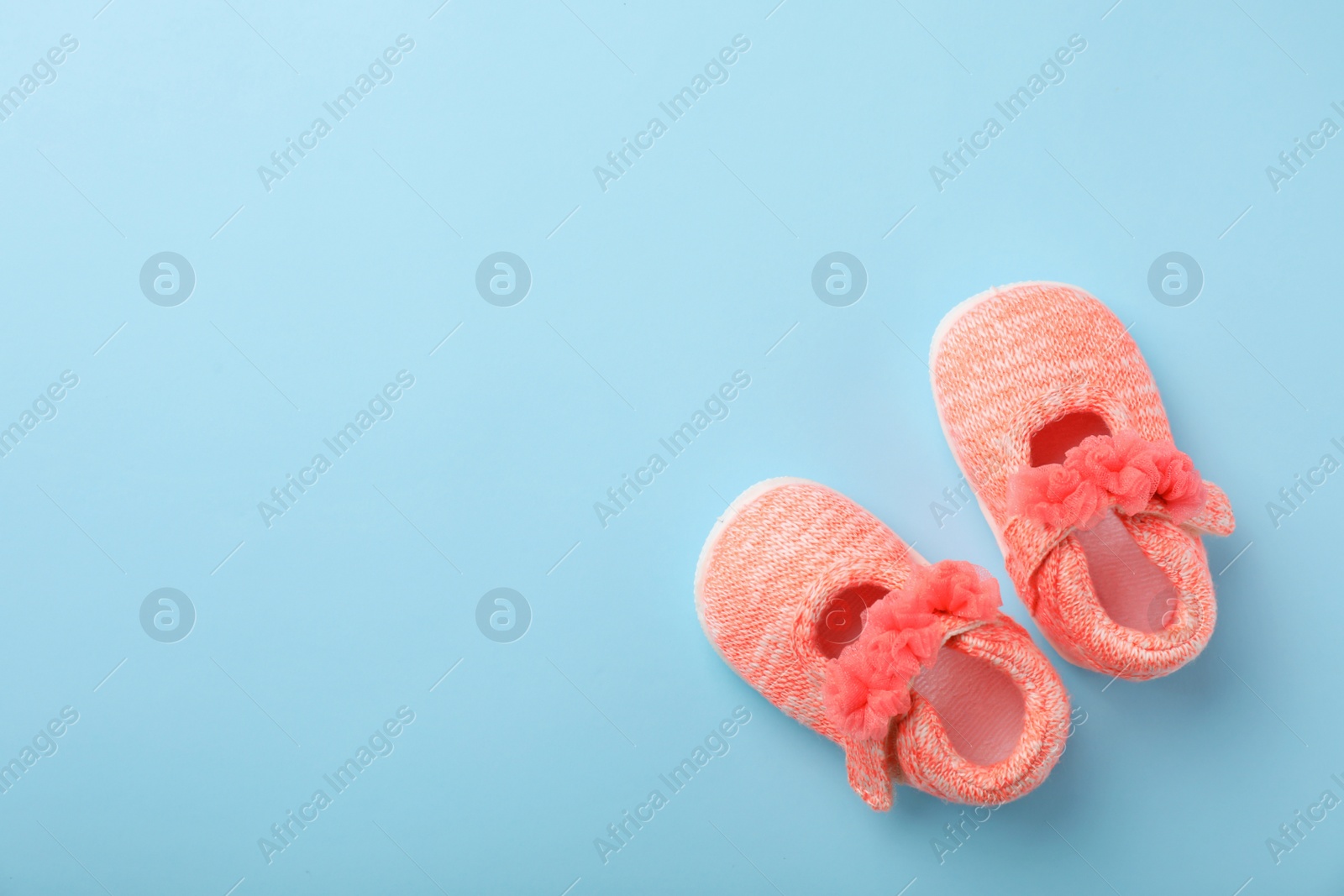 Photo of Pair of cute baby sandals on color background, top view