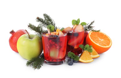 Aromatic Sangria drink in glasses, ingredients and Christmas decor on white background