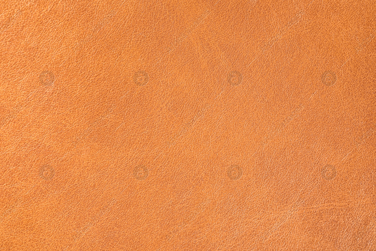 Photo of Texture of orange leather as background, closeup