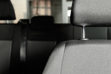 Photo of Car seat with grey upholstery, closeup view