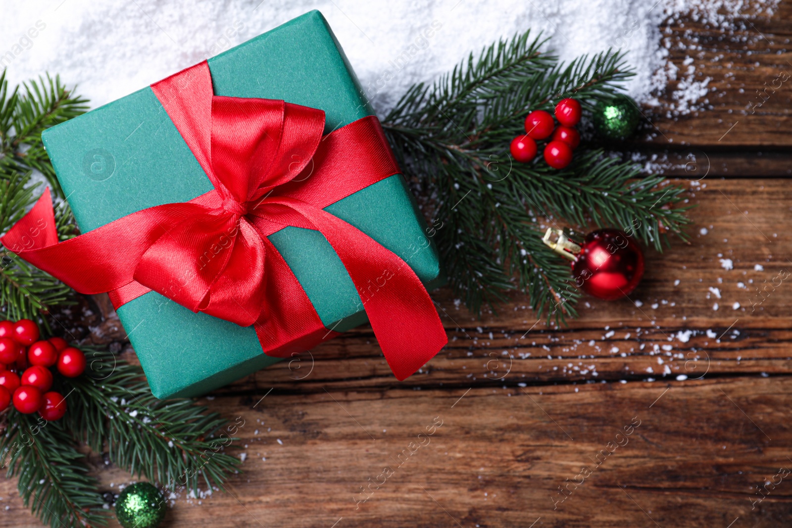 Photo of Flat lay composition with Christmas gift box on wooden table