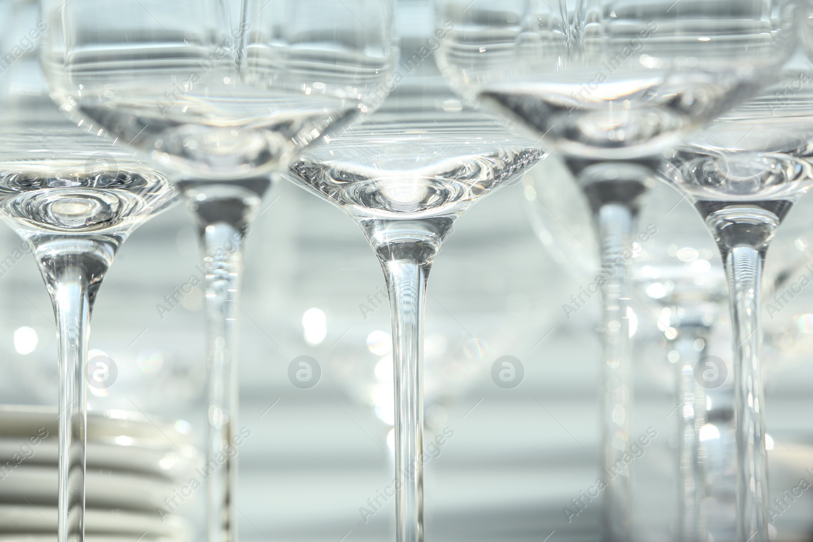 Photo of Set of empty wine glasses on blurred background, closeup