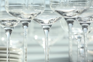 Photo of Set of empty wine glasses on blurred background, closeup