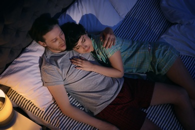 Young lovely couple sleeping in bed at home