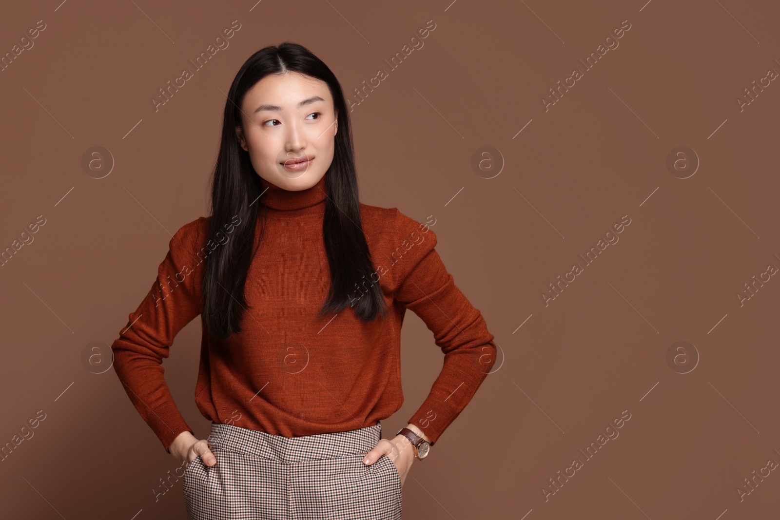 Photo of Portrait of beautiful woman on brown background. Space for text