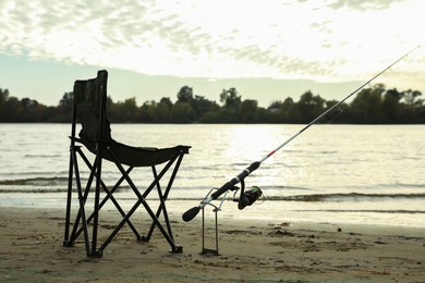 Photo of Folding chair and fishing rod at riverside