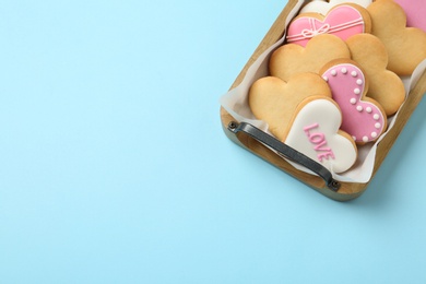 Tray with decorated heart shaped cookies and space for text on color background, top view