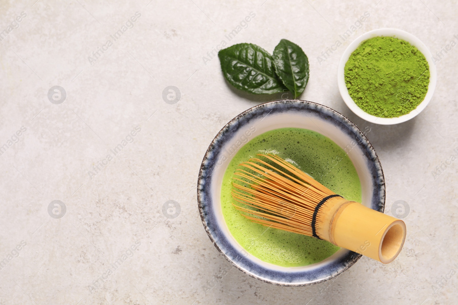 Photo of Flat lay composition with matcha tea on light gray textured table, space for text