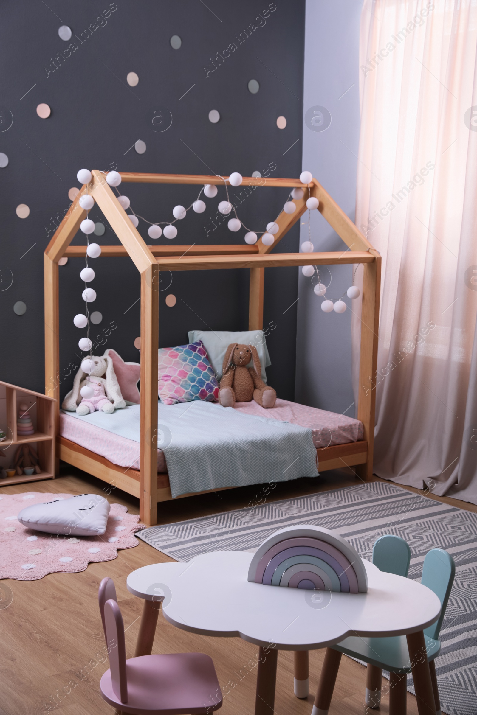 Photo of Stylish child room interior with comfortable bed