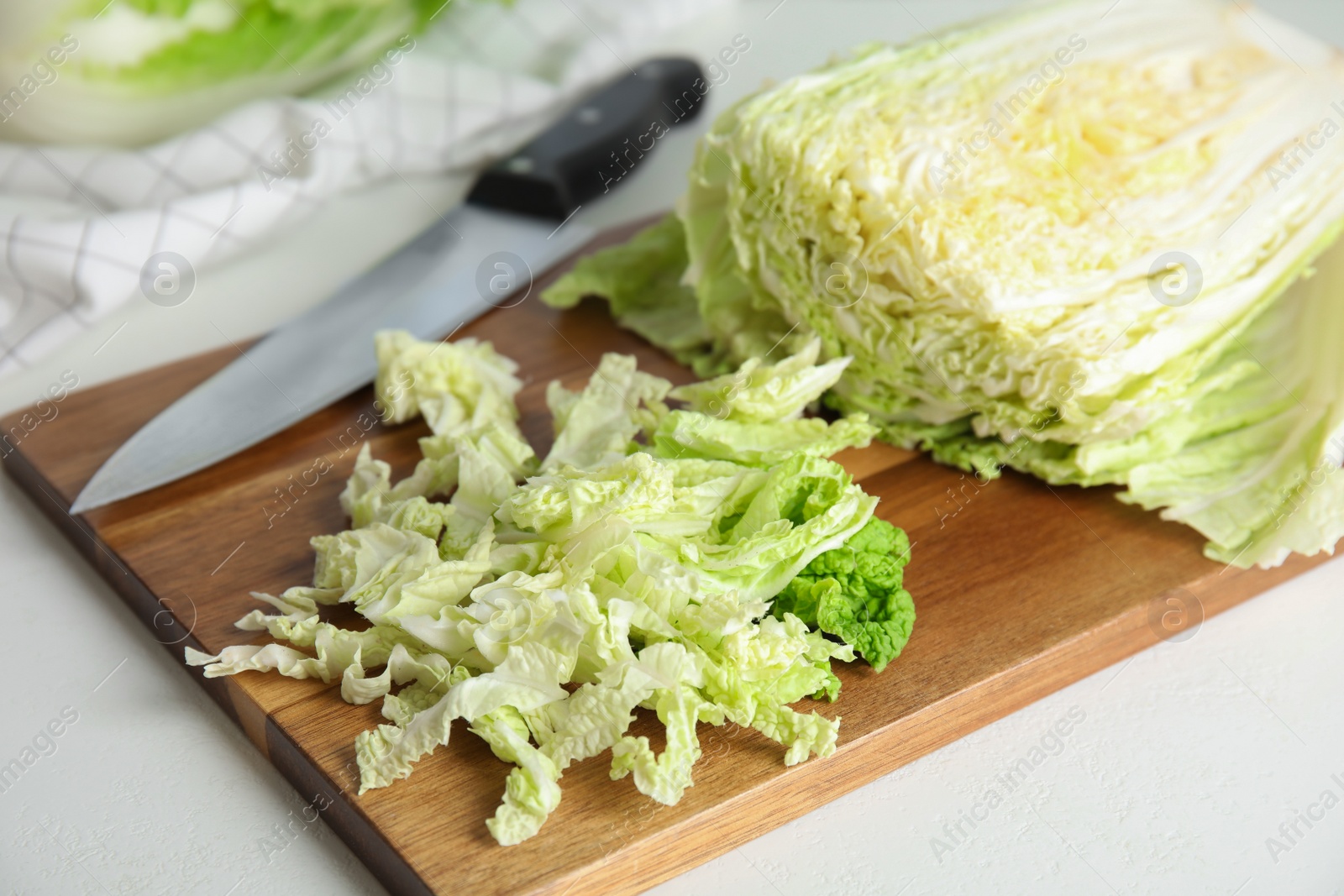 Photo of Chopped Chinese cabbage on wooden board, closeup