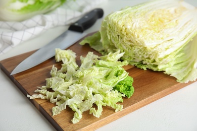 Photo of Chopped Chinese cabbage on wooden board, closeup