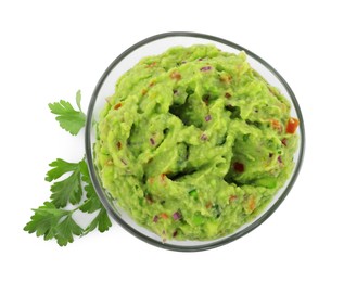 Photo of Bowl of delicious guacamole with parsley isolated on white, top view