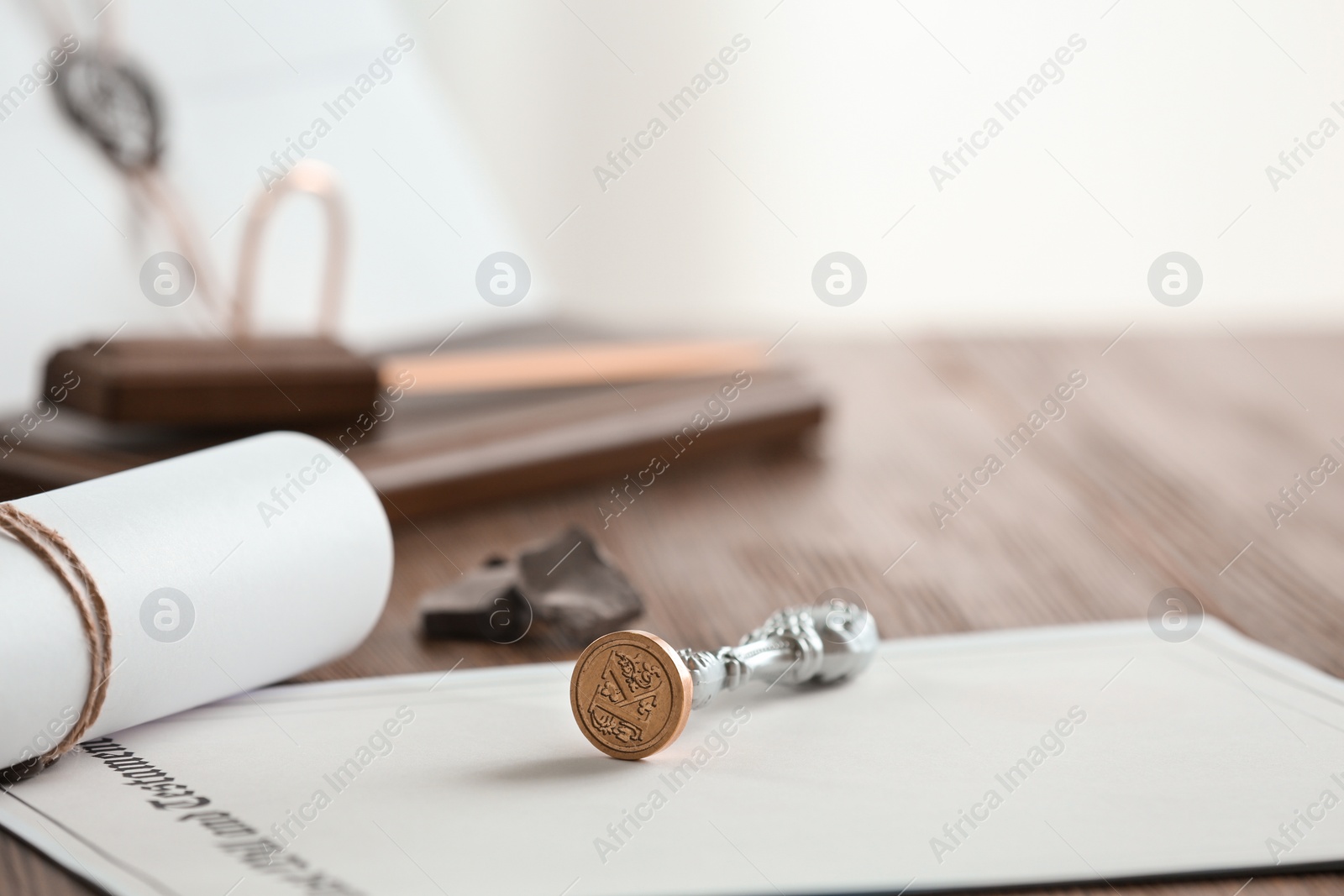 Photo of Vintage notary stamp and documents on wooden table, closeup. Space for text