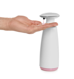 Photo of Man using automatic soap dispenser on white background, closeup