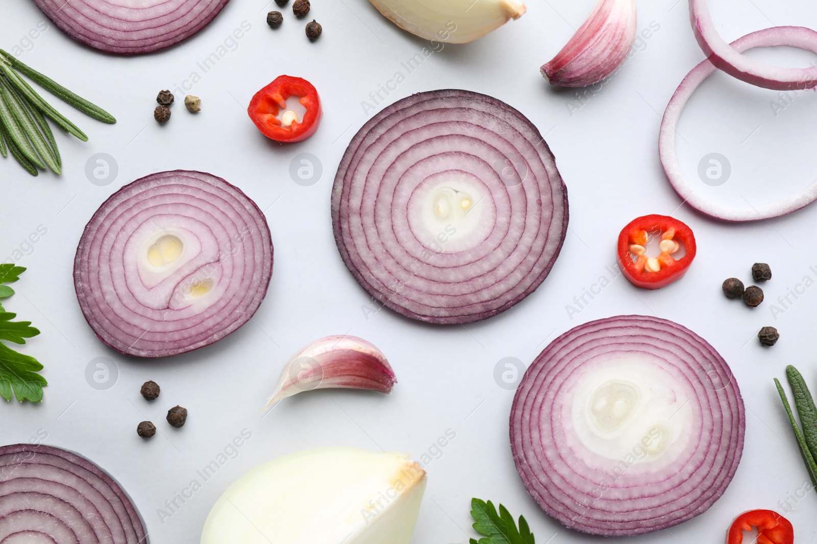 Photo of Flat lay composition with cut onion and spices on light background