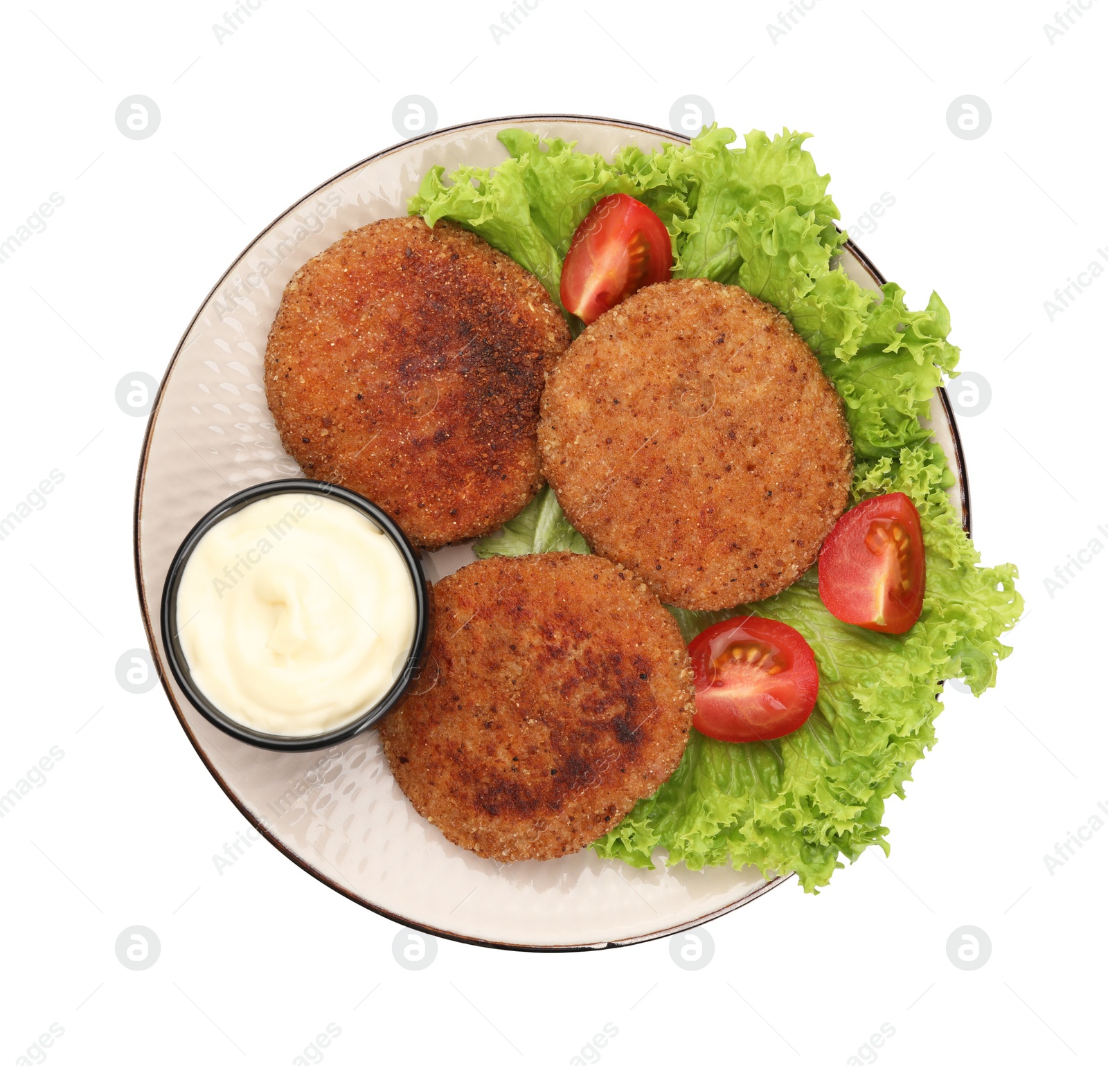 Photo of Plate with delicious vegan cutlets, lettuce, tomatoes and sauce isolated on white, top view