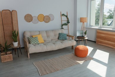 Beautiful living room interior with stylish beige sofa