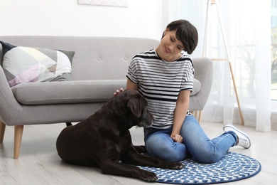 Adorable brown labrador retriever with owner at home