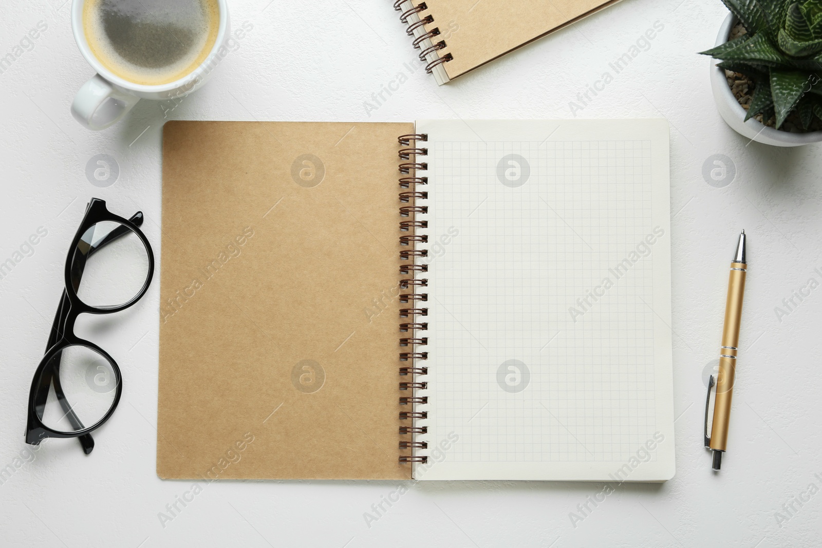 Photo of Flat lay composition with open notebook on white table. Space for text