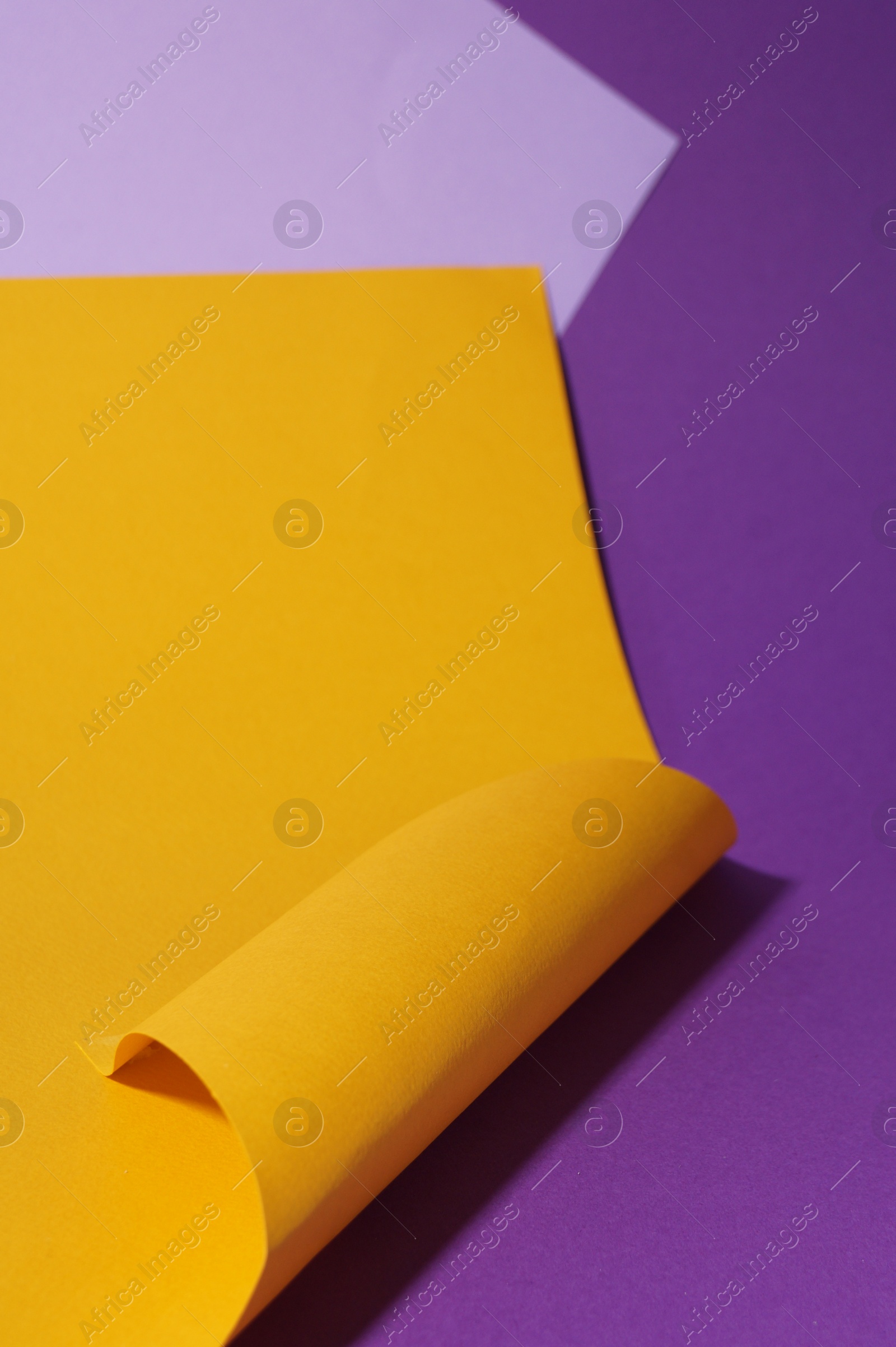 Photo of Different colorful paper sheets on purple background