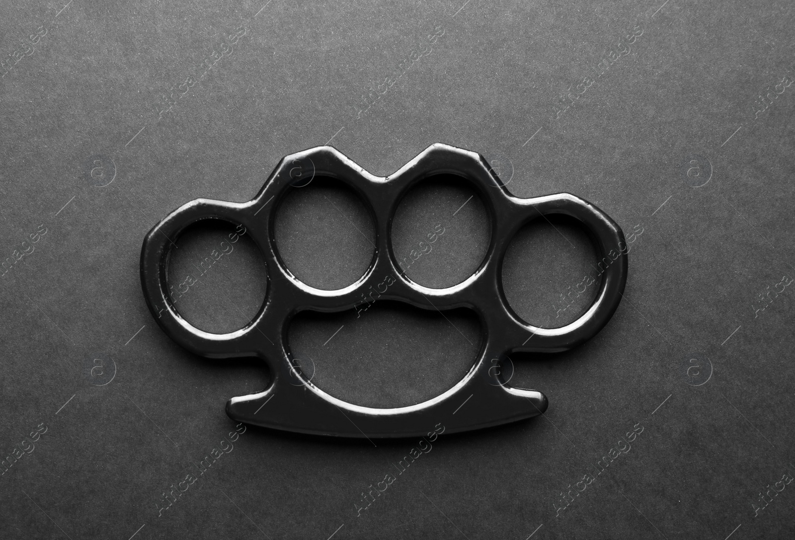 Photo of Brass knuckles on black background, top view