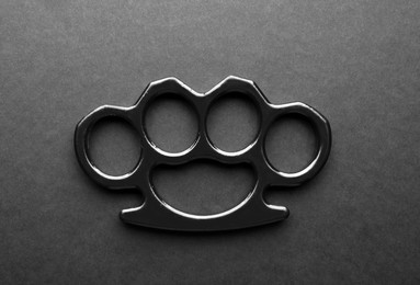 Photo of Brass knuckles on black background, top view