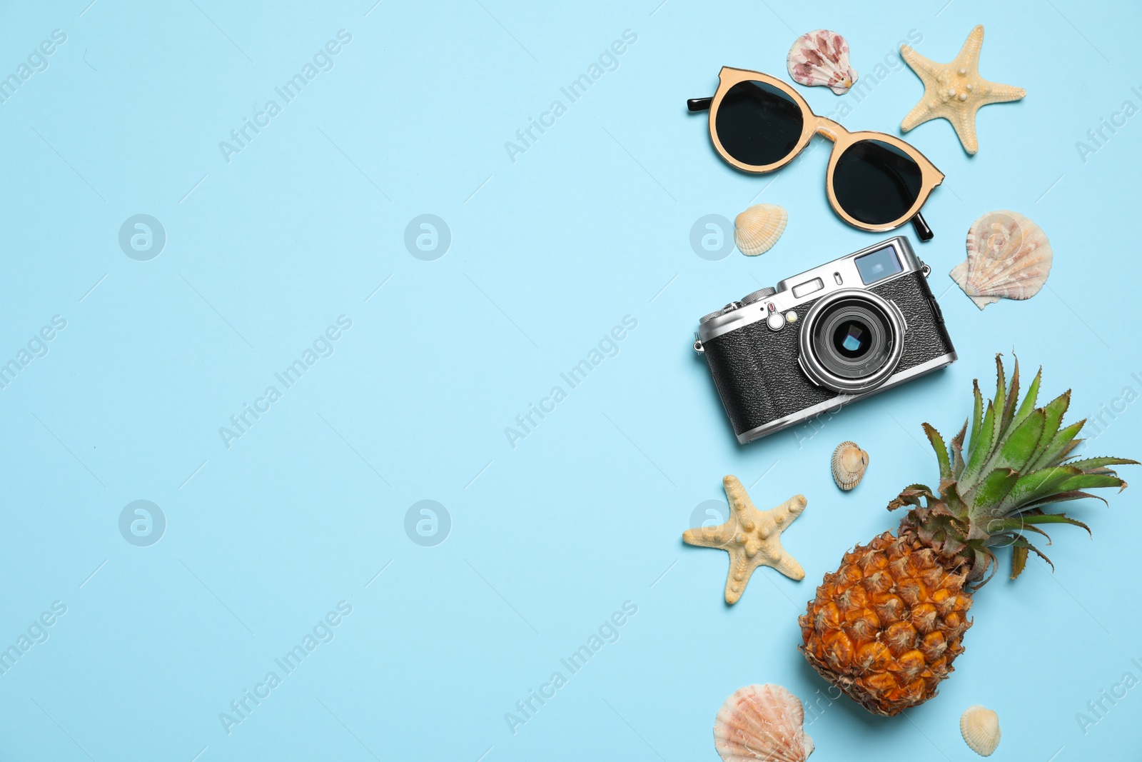 Photo of Flat lay composition with camera and sunglasses on color background, space for text. Beach accessories