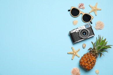 Photo of Flat lay composition with camera and sunglasses on color background, space for text. Beach accessories