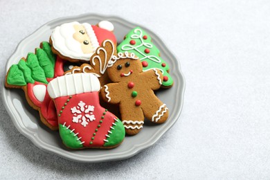 Tasty homemade Christmas cookies on light grey table. Space for text