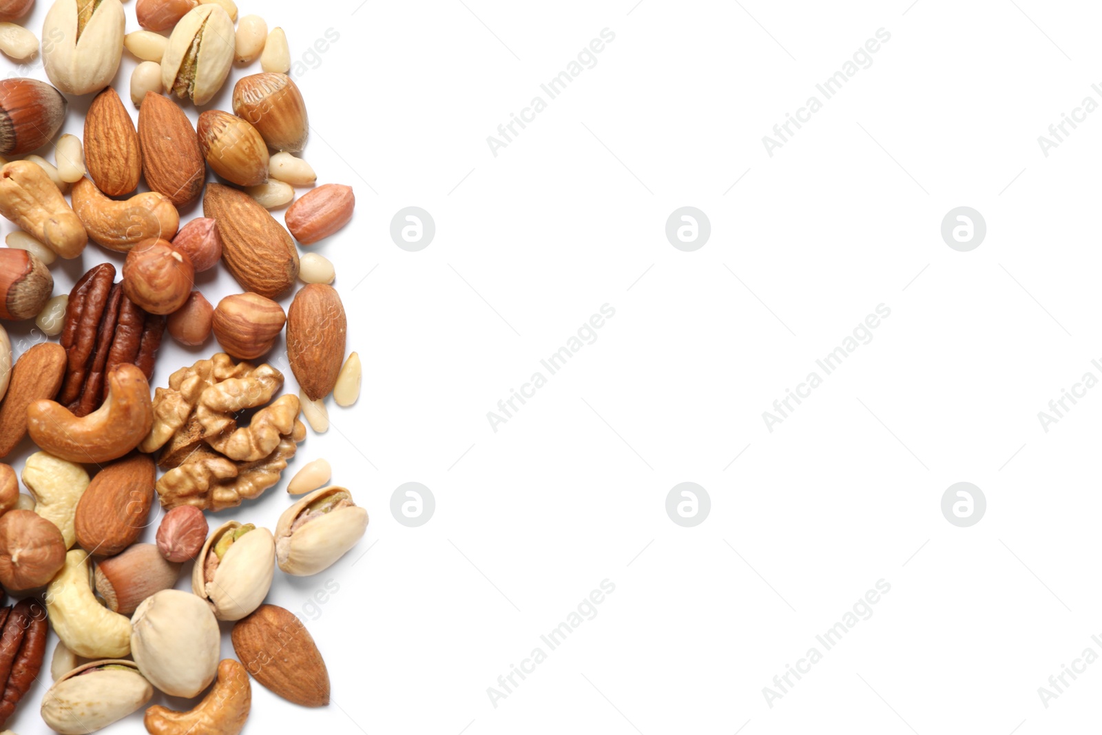 Photo of Different delicious nuts on white background, flat lay. Space for text