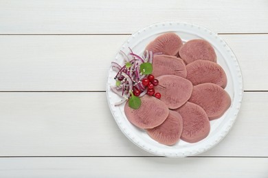 Photo of Tasty beef tongue pieces, berries and red onion on white wooden table, top view. Space for text