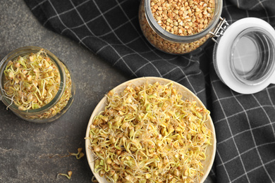 Photo of Flat lay composition with green buckwheat on grey table