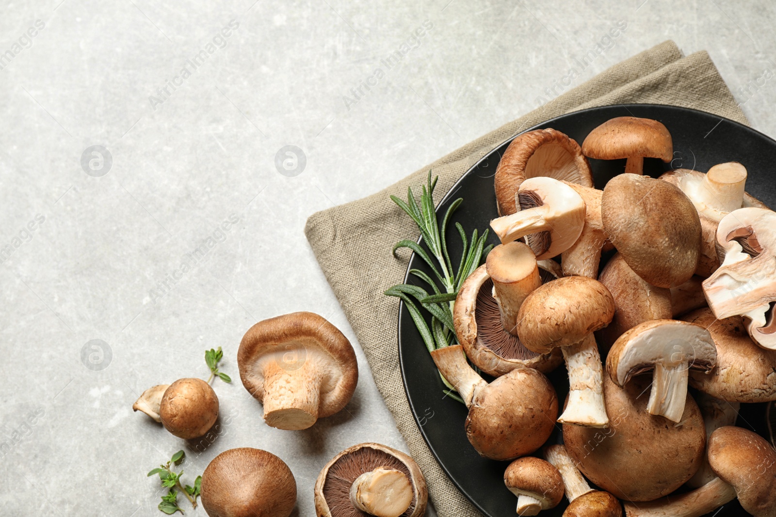 Photo of Flat lay composition with fresh wild mushrooms on light grey table