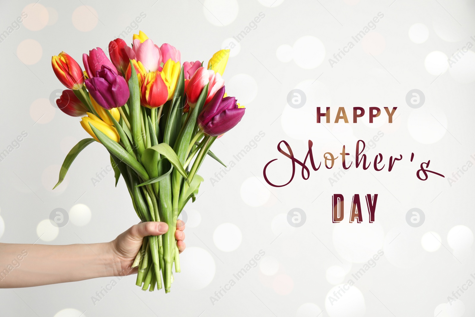 Image of Woman with bouquet of tulips and phrase HAPPY MOTHER'S DAY on light background, closeup