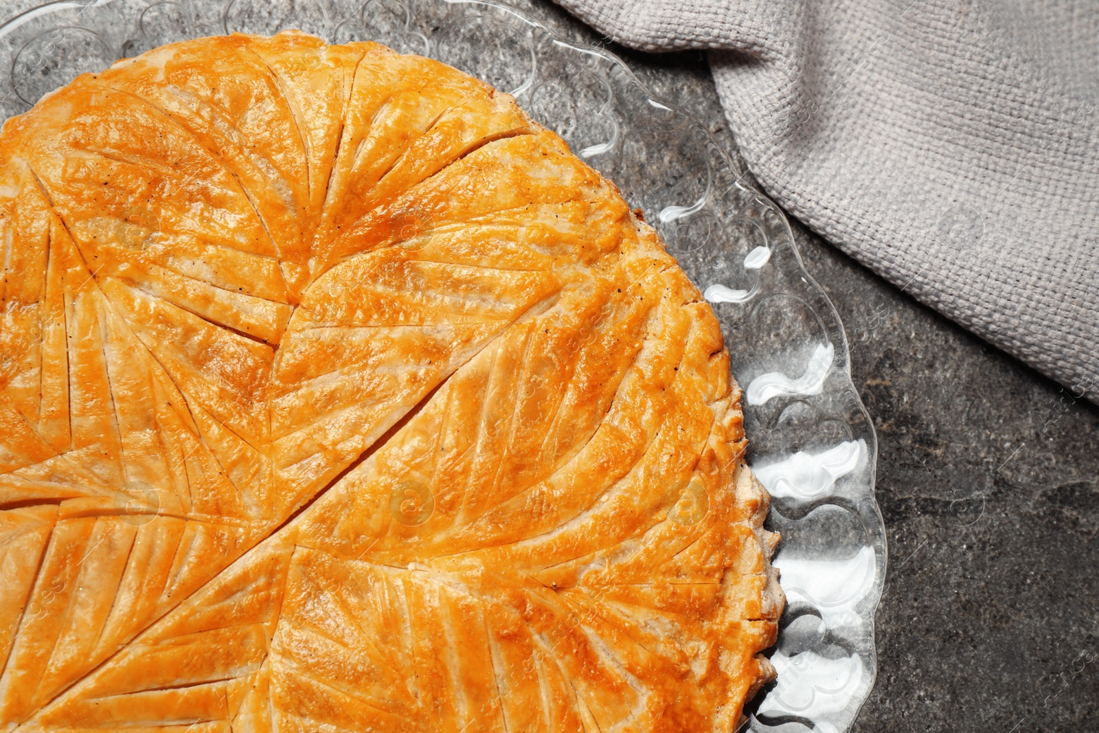 Photo of Traditional galette des rois on grey table, top view