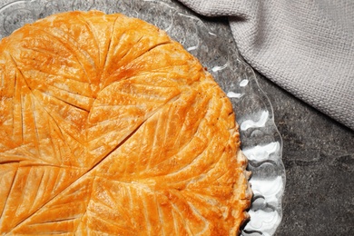 Traditional galette des rois on grey table, top view