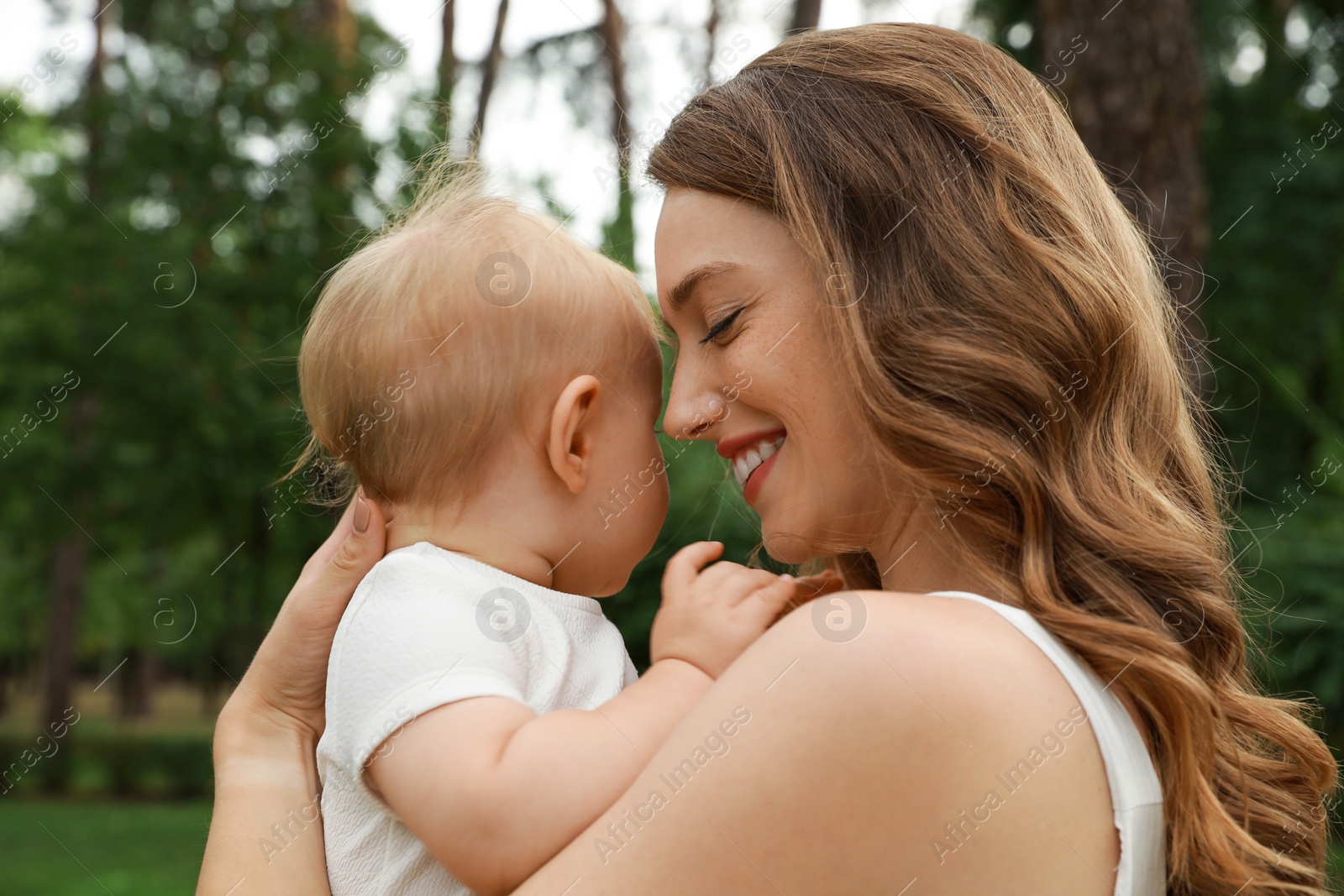 Photo of Mother with her cute baby spending time together outdoors