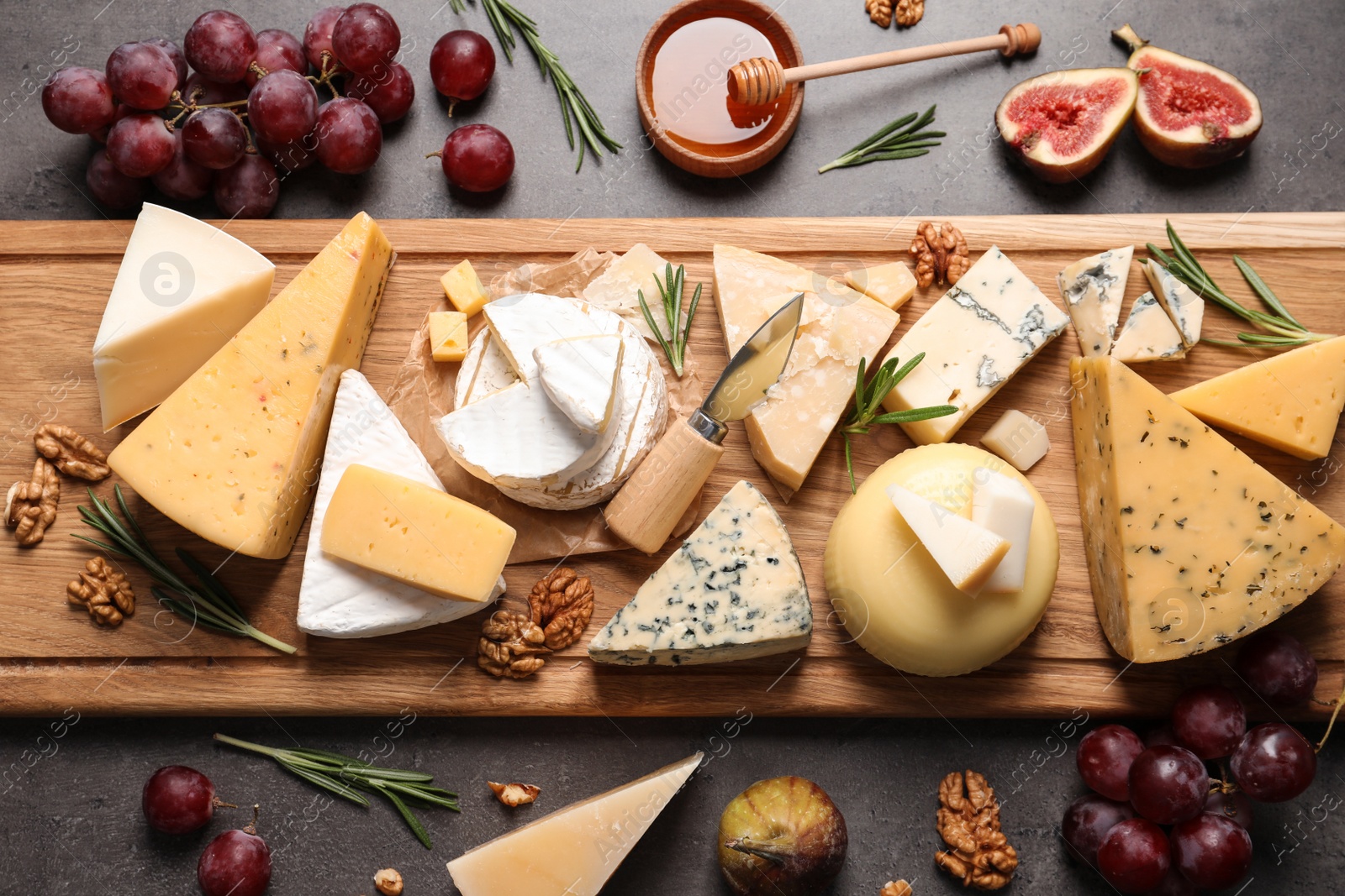 Photo of Flat lay composition with different types of delicious cheese on table