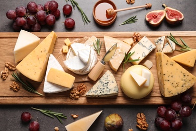 Photo of Flat lay composition with different types of delicious cheese on table